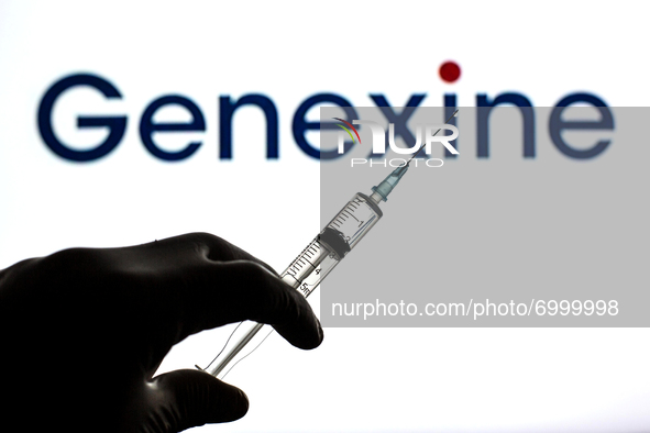In this photo illustration, a close up of a hand holding a medical syringe in front of the Genexine, Inc. logo 
