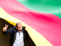 Kurdish demonstrators carry a long flag in the colors of Kurdistan  in Paris, France, on August 28, 2021. As the French and Iraqi presidents...