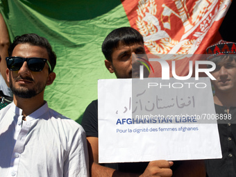 A man holds a placard 'Free Afghanistan. For the dignity of afghan women'. Dozens of members of the Afghani community of Toulouse organized...
