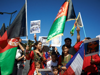 Young afghan girls wear traditional dress and hold Afghanistan'flag. Dozens of members of the Afghani community of Toulouse organized a gath...