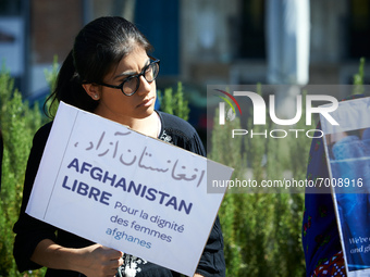 A young woman holds a placard reading 'Free Afghanistan. For the dignity of Afghan women'. Dozens of members of the Afghani community of Tou...
