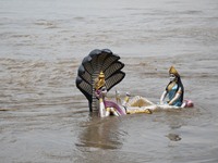 A statue of Lord Vishnu is seen submerged in the swollen Brahmaputra river, following heavy monsoon rain in Guwahati ,India on August 30,202...