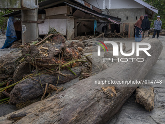 Residents are inside their houses which were covered in mud after being hit by a flash flood in Rogo Village, South Dolo District, Sigi Rege...