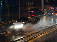 A vehicle rides through a waterlogged road during the heavy rain in Bangkok on September 1, 2021 in Bangkok, Thailand. (
