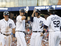 Detroit Tigers' Nick Castellanos celebrates with J.D. Martinez,center, Ian Kinsler,left, and Yoenis Cespedes,right, after his grand slam in...