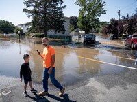 Residents survey flooding following torrential rains from the remannts of Hurricane Ida in Lodi, New Jersey, September 2, 2021. (