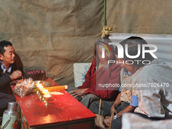 A 90 year-old Lepcha Bomthing (Lepcha priest) talks with villagers before performing prayers during an animal sacrifice ceremony to appease...