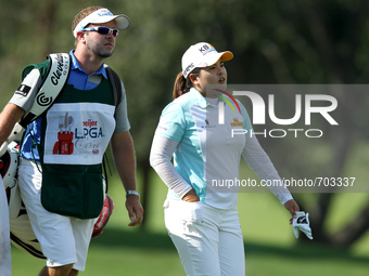 Inbee Park of Seoul, South Kore and caddie walk to the 9th hole during the first round of the Meijer LPGA Classic golf tournament at Blythef...
