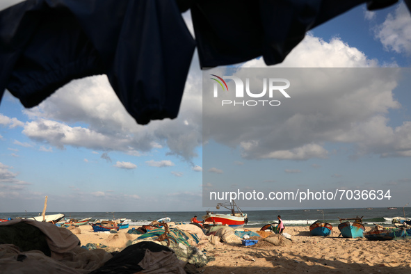 Palestinian fishermen work along a beach in Khan Yunis, southern Gaza Strip, on September 6, 2021.
 