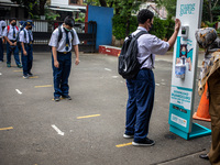 Rows of students queued to check body temperature by keeping their distance, in South Tangerang, Indonesia, on September 6, 2021. Indonesia...
