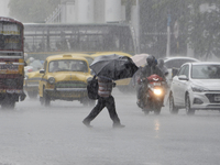 A man with an umbrella crosses a road during heavy rainfall in Kolkata, India, 06 September, 2021.  (
