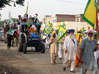 Farmers participate in a protest march as part of a farmers' protest against farm laws during a meeting at Karnal in the northern state of H...