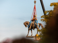The statue of Confederate general Robert E. Lee is removed from its enormous pedestal on Monument Avenue.  The Virginia supreme court ruled...