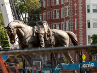 The headless statue of Confederate general Robert E. Lee as it is separated into two pieces for transport.  The Virginia supreme court ruled...
