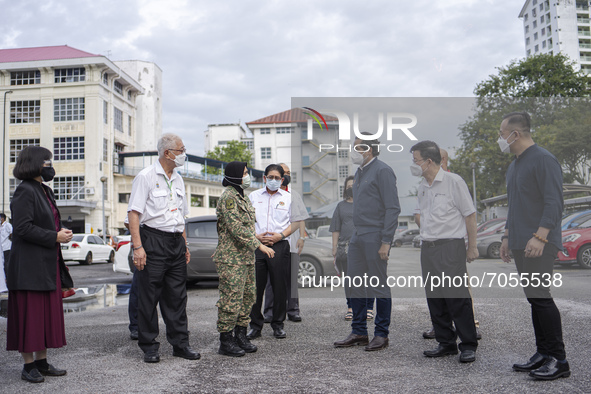 Malaysian Health Minister Khairy Jamaluddin (three from right) talks to army personnel at Penang Hospital in his first official working visi...
