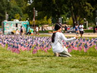 A mother and daughter take a selfie amid 2,977 American flags on the National Mall near the Capitol, one for each victim of the September 11...