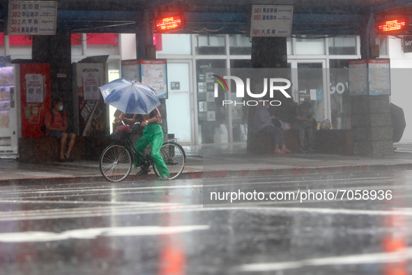 A cyclist seen in strong rains and winds in Keelung, as Typhoon Chanthu bringing torrential rains and damaging winds makes landfall on the i...
