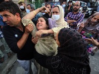 SRINAGAR, KASHMIR, INDIA-SEPTEMBER 12: Mother (C) of the police officer wailing during the wreath laying ceremony at District Police Lines i...