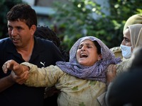 SRINAGAR, KASHMIR, INDIA-SEPTEMBER 12: Mother (C) of the police officer wailing during the wreath laying ceremony at District Police Lines i...