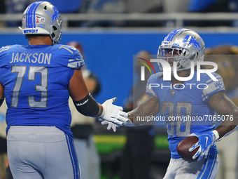 Detroit Lions running back Jamaal Williams (30) celebrates his touchdown with offensive guard Jonah Jackson (73) during the second half of a...