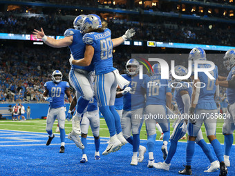 Detroit Lions tight end T.J. Hockenson (88) celebrates his touchdown with offensive guard Frank Ragnow (77) during the first half of an NFL...