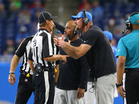 Detroit Lions head coach Dan Campbell talks to Down Judge Kent Payne during the second half of an NFL football game against the San Francisc...
