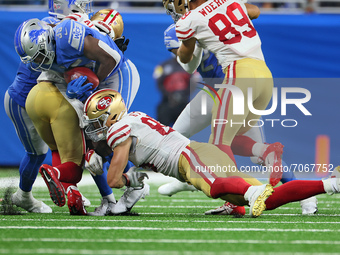 Detroit Lions running back Godwin Igwebuike (35) is taken down while carrying the ball by San Francisco 49ers tight end George Kittle (85) d...
