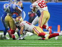 Detroit Lions running back Godwin Igwebuike (35) is taken down while carrying the ball by San Francisco 49ers tight end George Kittle (85) d...