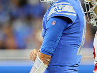 Detroit Lions quarterback Jared Goff (16) talks with teammates after being sacked during a play during an NFL football game between the Detr...