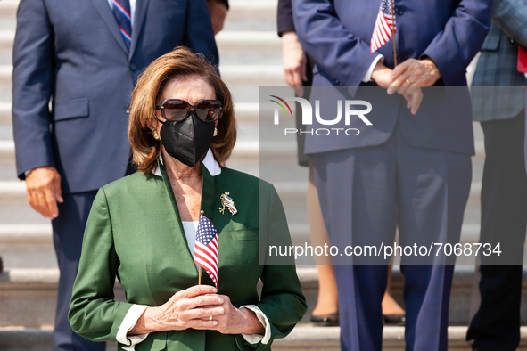 House Speaker Nancy Pelosi (D-CA) holds an American flag during a ceremony in the Capitol steps in remembrance of the victims of the Septemb...