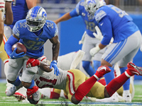 Detroit Lions running back D'Andre Swift (32) is tackled by San Francisco 49ers linebacker Azeez Al-Shaair (51) during an NFL football game...