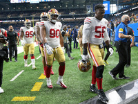 San Francisco 49ers players return to the locker room after warmups during an NFL football game against the Detroit Lions in Detroit, Michig...