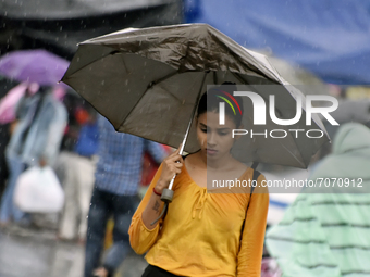 A girl with an umbrella ca be seen during heavy rainfall in Kolkata, India, 14 September, 2021.   (