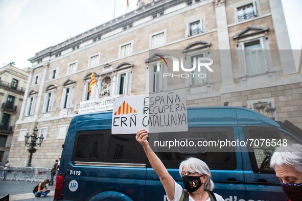 Protester in front of a police van is seen with a banner that reads, Spain recovers Catalonia.
The political party The Popular Unity Candida...