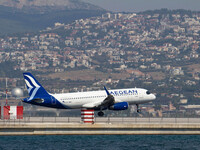 An Aegean Airlines Airbus A320 aircraft painted with the new livery and company logo as seen landing over the sea at runway 10/28 that is ex...