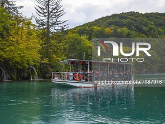 Tourits swim on a boat on Plitvice Lakes in National Park in Croatia on September 15, 2021. In 1979, Plitvice Lakes National Park was inscri...