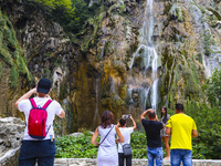 Tourists watch the Great Waterfall (Veliki Slap) at Plitvice Lakes National Park in Croatia on September 15, 2021. In 1979, Plitvice Lakes N...