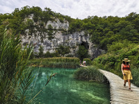 A woman walks a wooden path trail at Plitvice Lakes National Park in Croatia on September 15, 2021. In 1979, Plitvice Lakes National Park wa...