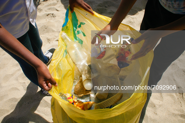 Volunteers pick up trash during a World Beaches Day collection day amidst the Coronavirus pandemic in La Guaira, Venezuela on September 18,...