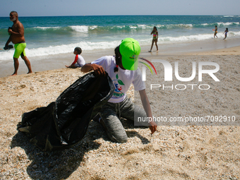 A volunteer picks up trash during a World Beaches Day collection day amidst the Coronavirus pandemic in La Guaira, Venezuela on September 18...