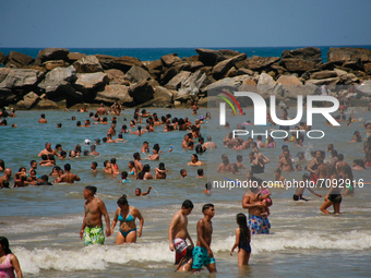 People swim at the beach during World Beaches Day amidst the Coronavirus pandemic in La Guaira, Venezuela on September 18, 2021. (