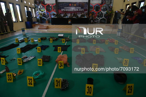 Police show a number of evidences that were seized after a shootout occurred between officers from the Madago Raya Task Force and the Poso E...