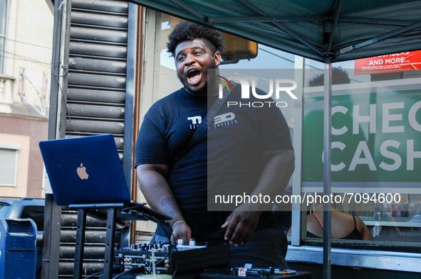 A DJ jams, out turning all of Germantown into a casual street fest as a unique form of protest intended to draw in people who might not othe...