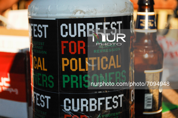 A donation bucket rests on the table of a DJ advertising for CurbFest, during a rally in the Germantown section of Philadelphia, PA, on Sept...