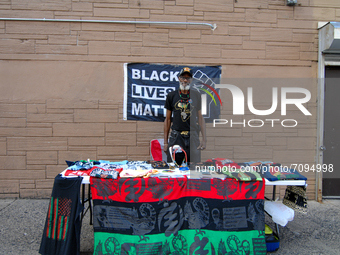 A member of the National Association for Black Veterans, tables at CurbFest for the liberation of political prisoners held by the United Sta...