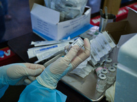 A health worker prepares a dose of the AstraZeneca COVID-19 vaccine in a vehicle of BKK Mobile Vaccination Unit on September 20, 2021 in Ban...