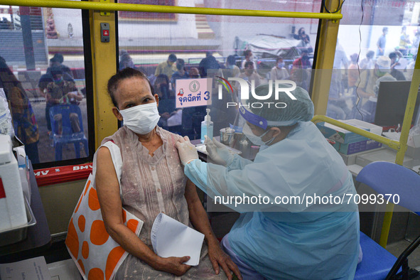 An elderly woman receives a dose of AstraZeneca COVID-19 vaccine in a vehicle of the BKK Mobile Vaccination Unit on September 20, 2021 in Ba...