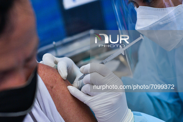 A man receives a dose of AstraZeneca COVID-19 vaccine in a vehicle of BKK Mobile Vaccination Unit on September 20, 2021 in Bangkok, Thailand...