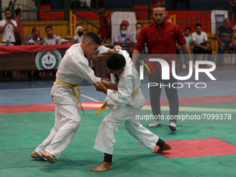 Palestinian players fight during a local Judo Championship, in Gaza city on September 19, 2021. Judo is generally categorized as a modern Ja...