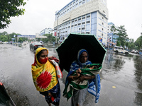 A woman holds umbrella during heavy rain in Kolkata on September 20,2021. (